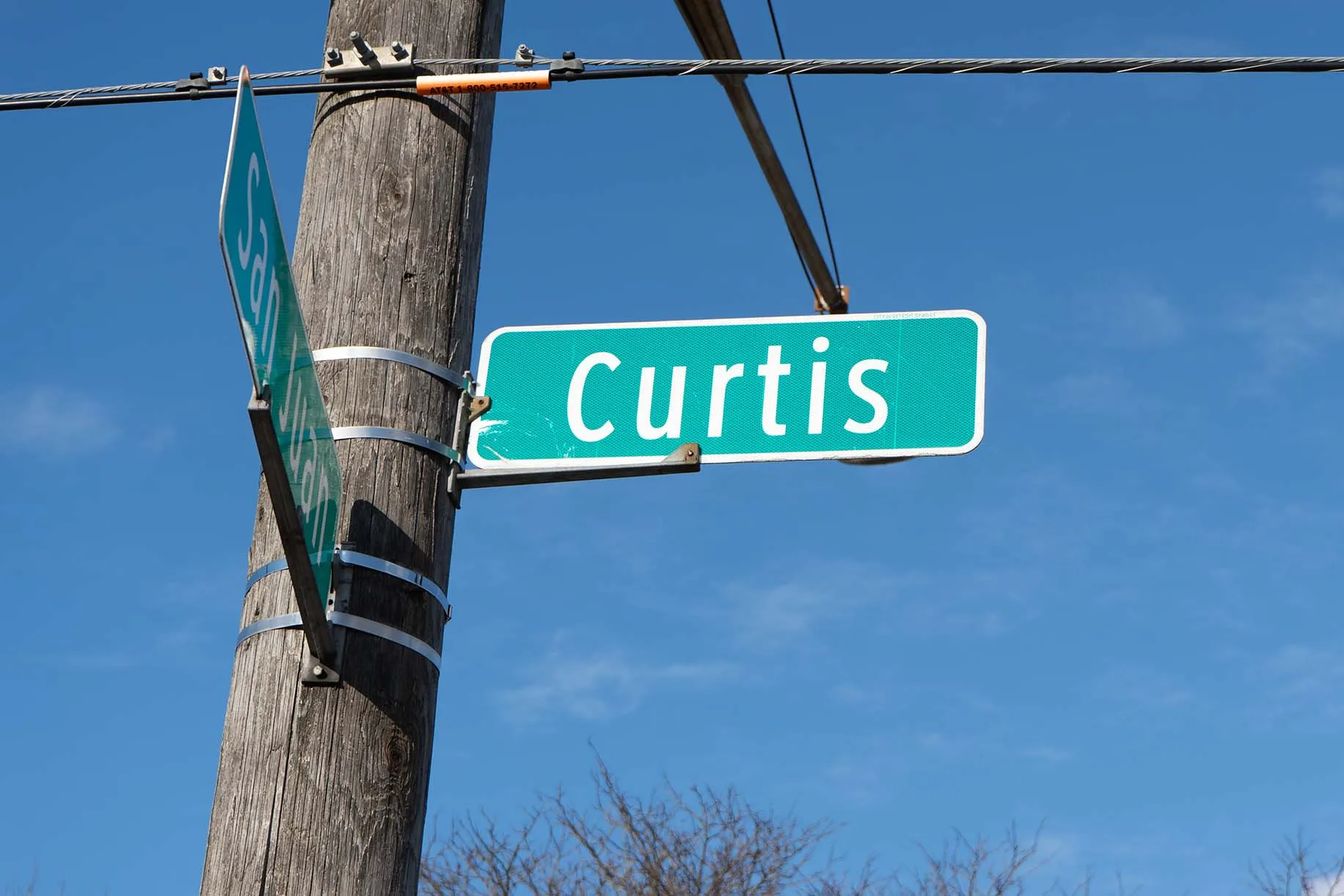 A street sign at the intersection of Curtis and San Juan